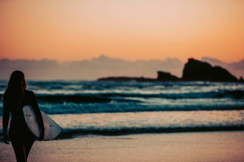 Surfers Paradise skyline rising behind Main Beach buildings at dusk