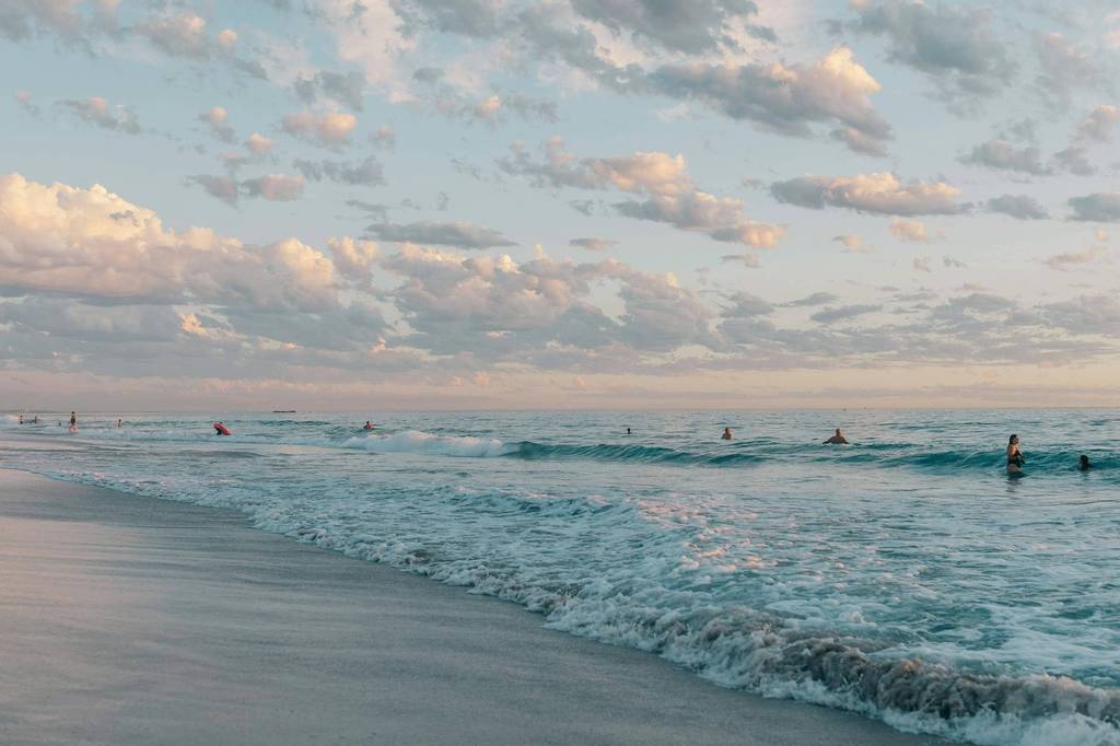 Open beach view over the Pacific with rolling surf and sky