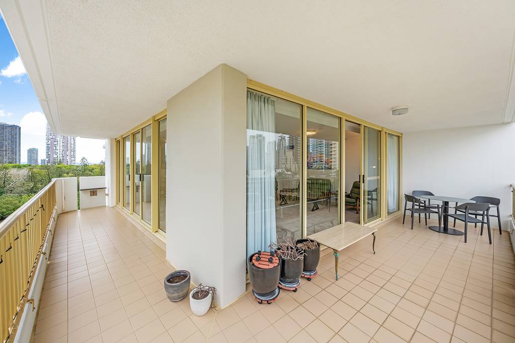 Wraparound balcony with outdoor dining area and glass doors